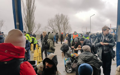 group of people aiding Ukraine relief for one another in parking lot